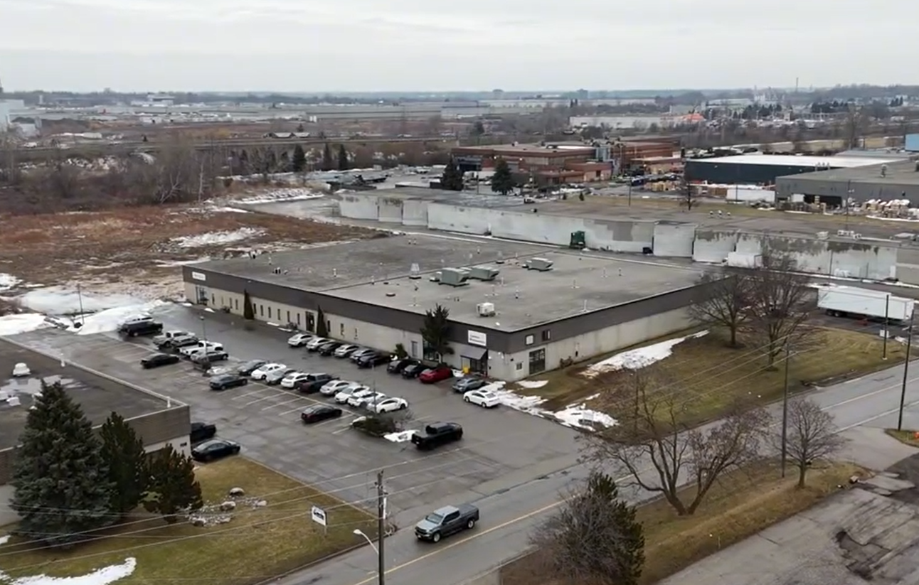 Aerial view of the 40,000 sq ft Sandha Woodworks millwork facility with dust collector and parking